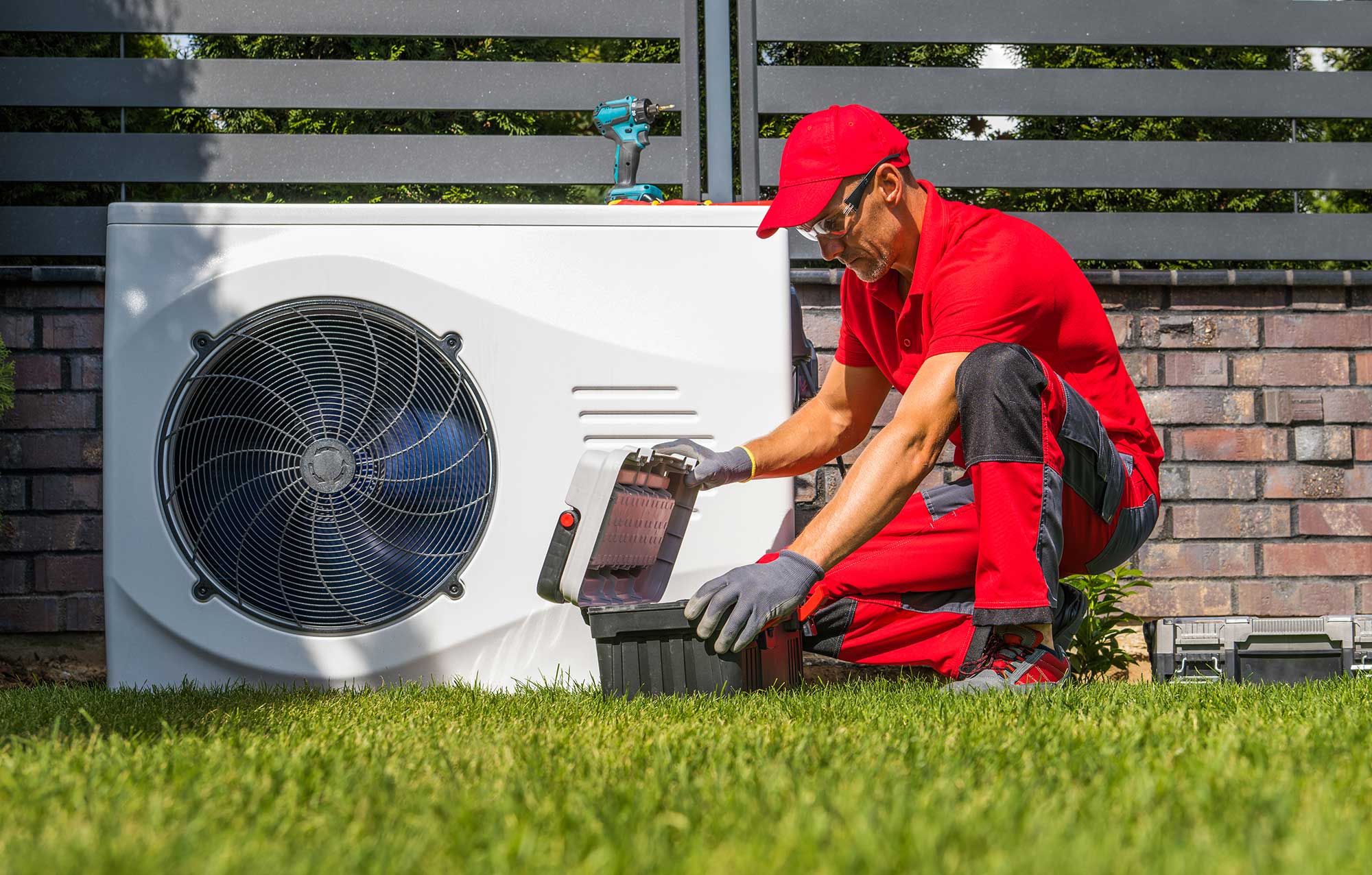Technician installing a new heat pump to improve energy efficiency in a Grove City, OH home.